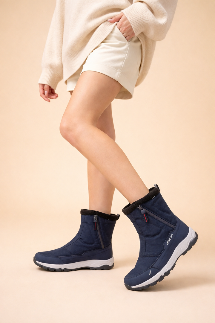 Fashionable women's winter boots with practical side zip, ready for snow, offering warmth and sturdy grip.