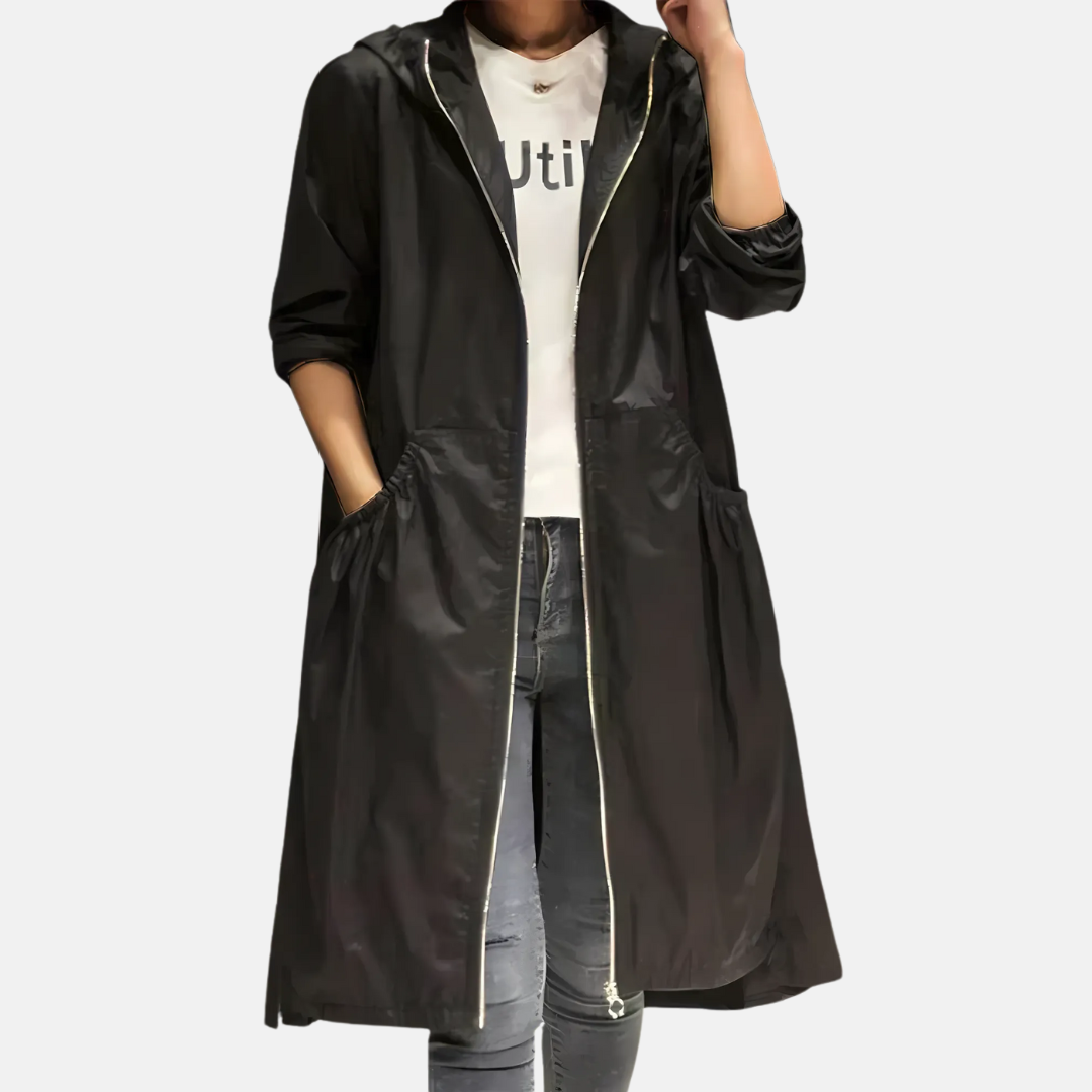Stylish women's knee-length hooded rain jacket, water-resistant outerwear ideal for travel & spring.