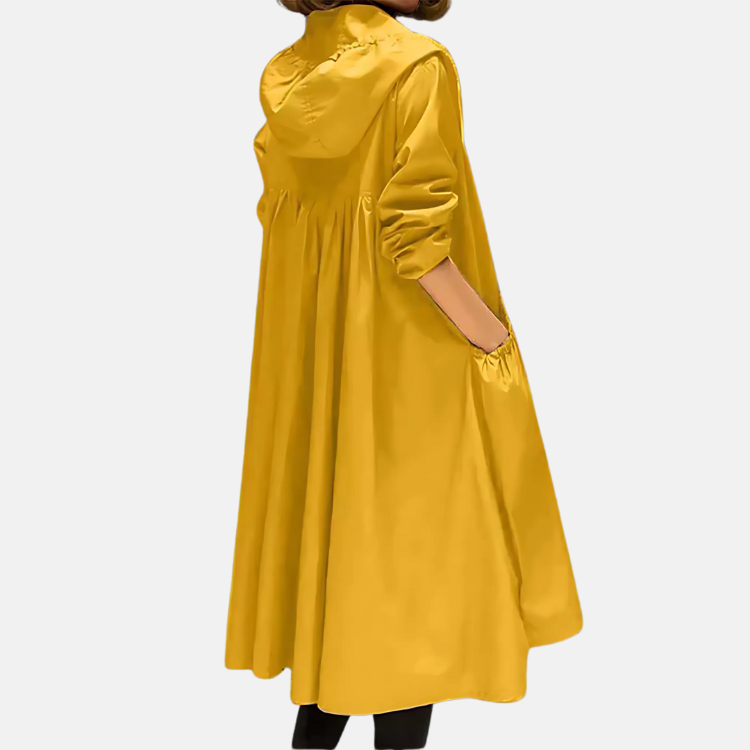 Women's hooded water-resistant knee-length jacket, essential travel gear for rainy spring and fall days.