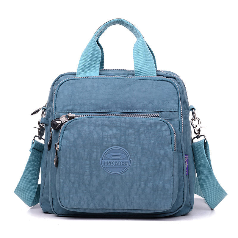Modern women's water-resistant crossbody bag, ideal for busy, organized women on the move.