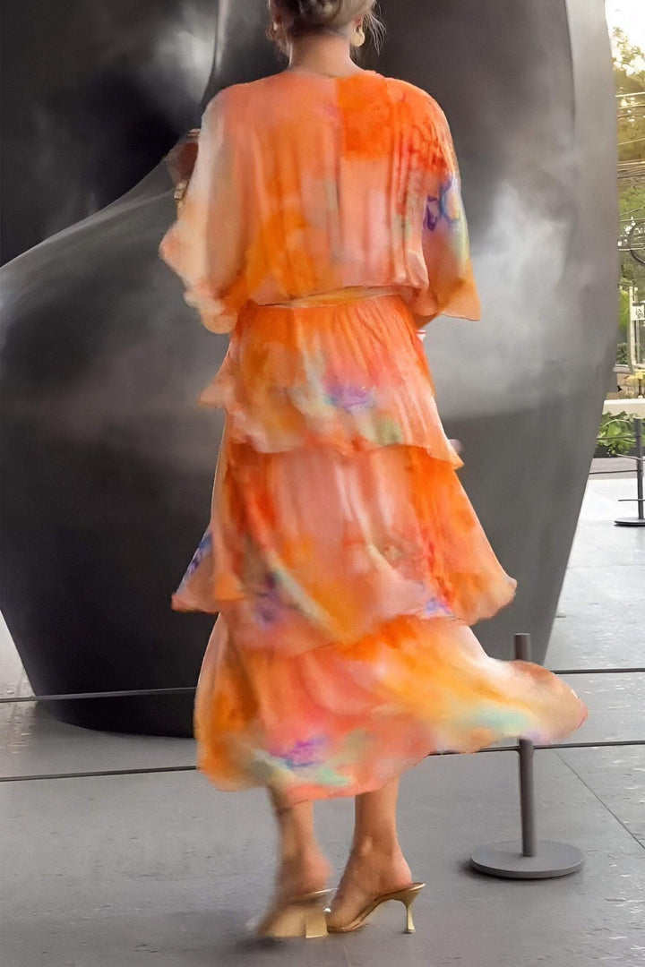 Graceful women's tiered chiffon maxi dress featuring a vibrant watercolour floral print, ideal for special events.