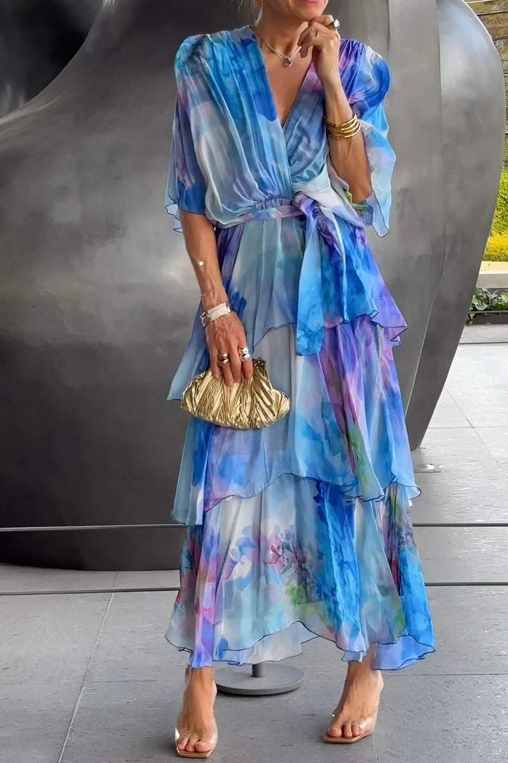 Women's long tiered maxi dress in chiffon, showcasing a vibrant watercolour floral pattern, elegant party wear.
