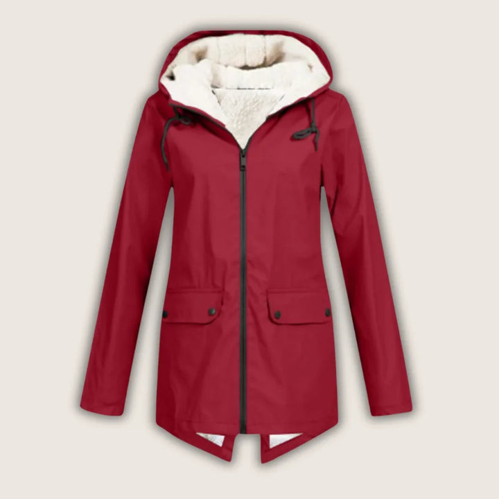 Women's waterproof hooded jacket with front pockets, ideal for rain and outdoor activities.