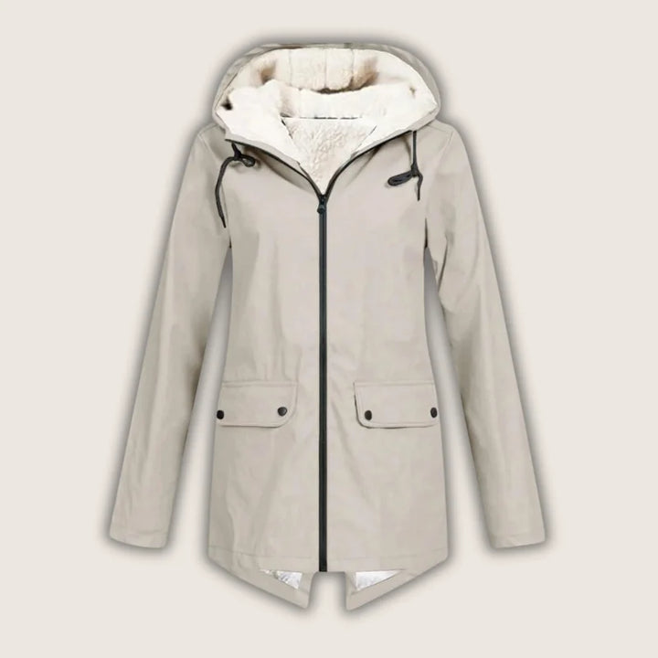 Protective women's waterproof hooded outerwear with practical front pockets, excellent for rainy days.