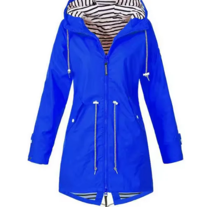 Woman hiking in a waterproof hooded outdoor jacket, ideal for active adventures and protection from rain and wind.