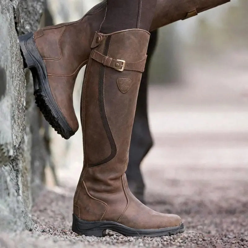 Elegant women's black waterproof knee-high boots with side zip closure, ideal for stylish weather protection.