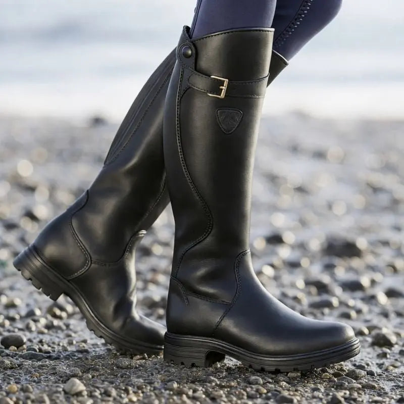 Close-up of a women's waterproof knee-high boot, highlighting the secure side zip and weather-resistant material.