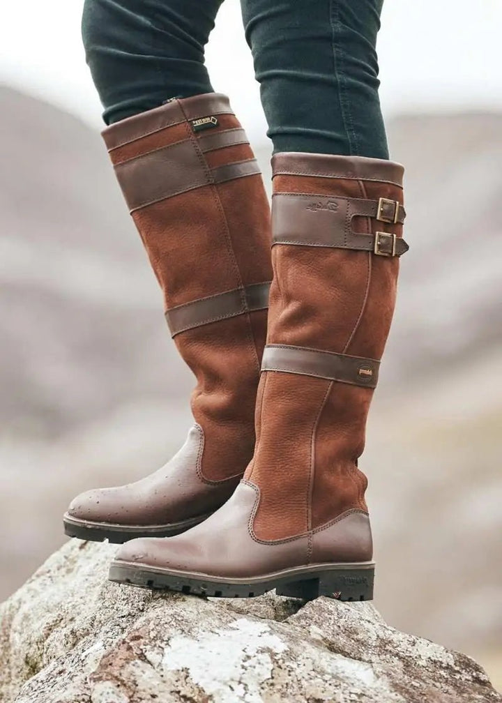 Chic women's knee-high country boots. Waterproof & durable pull-on design for equestrian fashion & all-weather comfort.