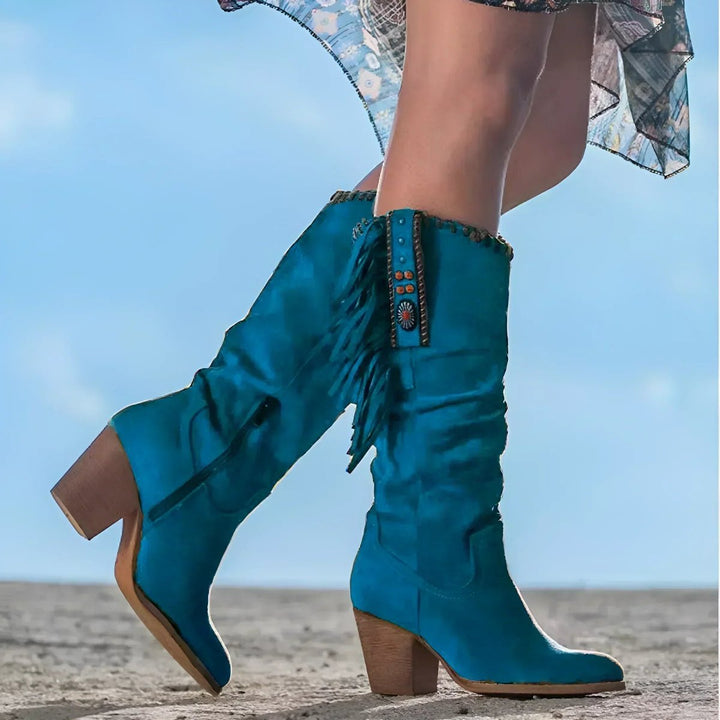 Statement women's cowboy boots with turquoise accents & flowy fringe, a unique Western style with a block heel.