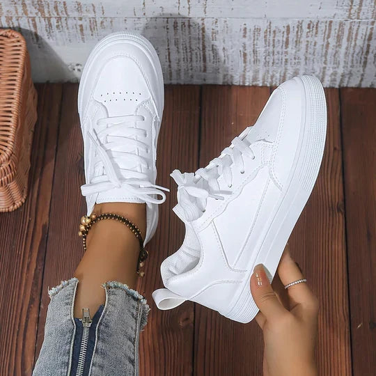 Women's white casual sneakers for daily wear, offering all-day comfort and stylish versatility.