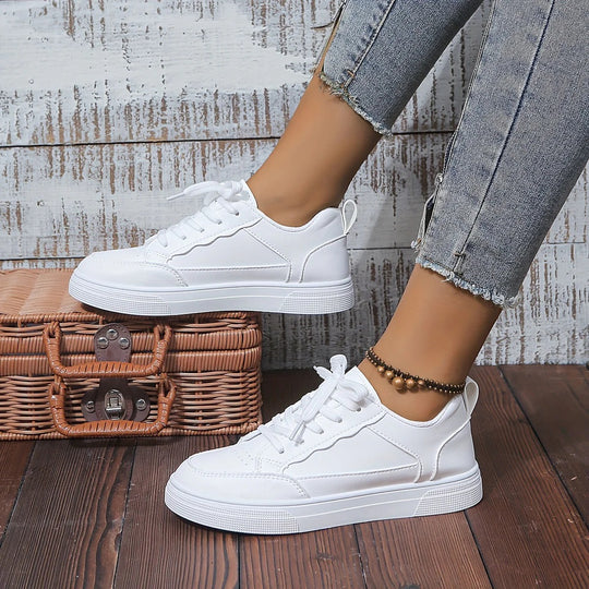 Comfortable white women's sneakers, perfect for walking and casual outfits. Ergonomic design for all-day support.