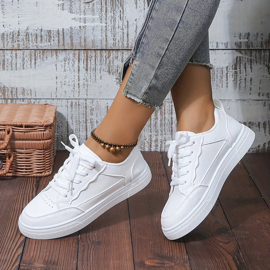 Stylish white casual women's sneakers. Versatile footwear for daily comfort, ideal for active lifestyles.
