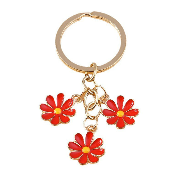 Elegant white daisy flower key charm. Durable enamel finish for a fashionable bag or key accessory.