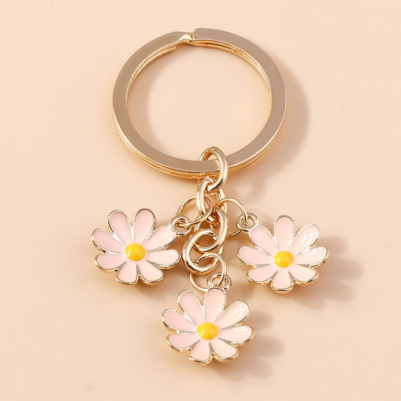 Charming daisy flower key organizer. Metal and enamel keychain adds a cute floral accent to keys & bags.