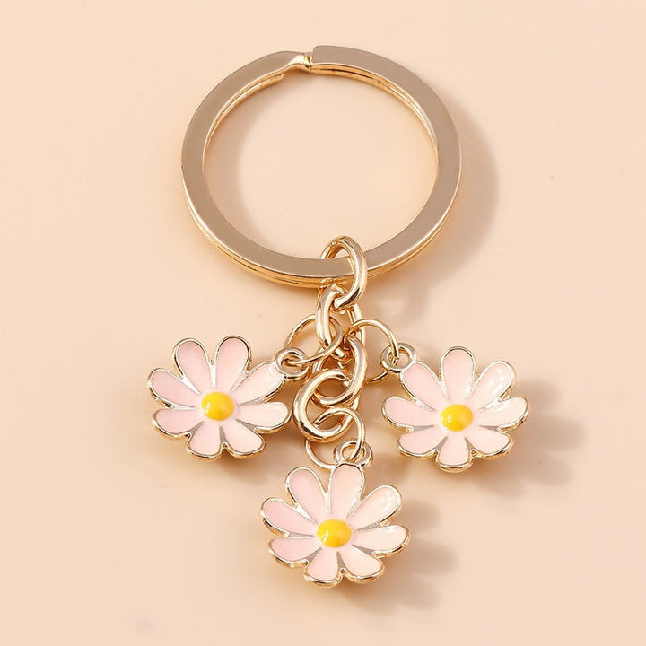 Charming daisy flower key organizer. Metal and enamel keychain adds a cute floral accent to keys & bags.