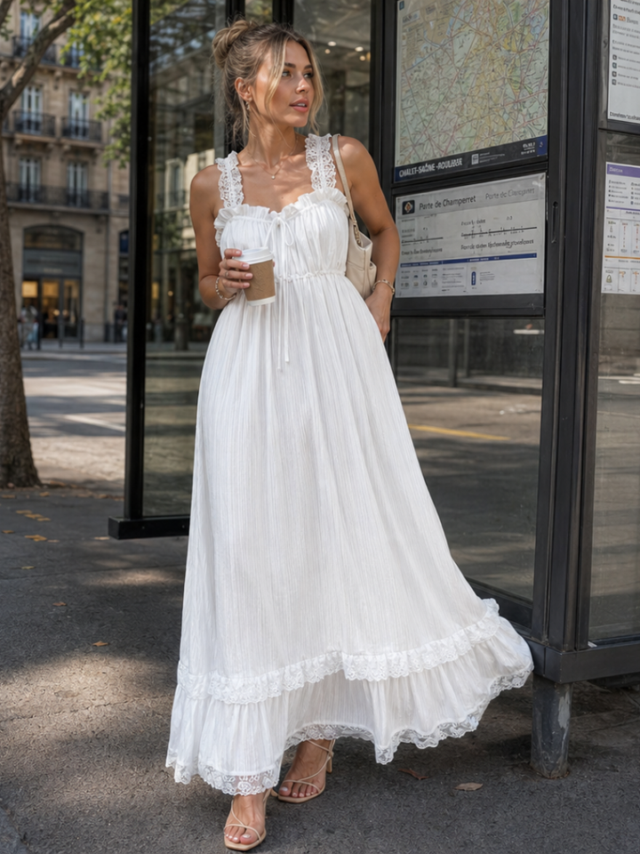 Women's white flowing midi dress with ruffle straps, perfect for a comfortable & elegant summer or vacation look.