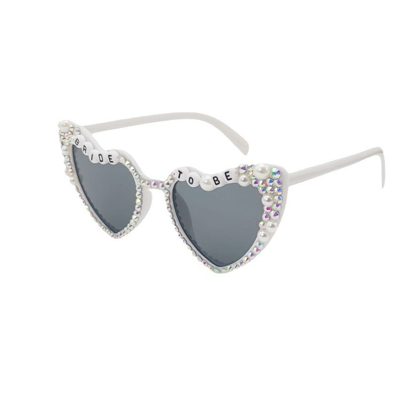 Fashionable women's heart-shaped party sunglasses with UV protection for wedding festivities.