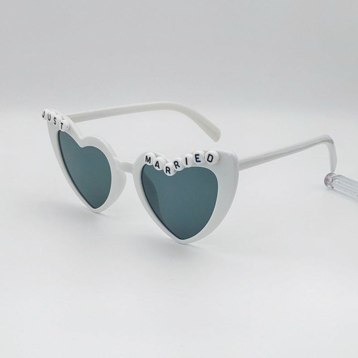 Chic women's heart bridal sunglasses, enhancing any bachelorette party or wedding photo.