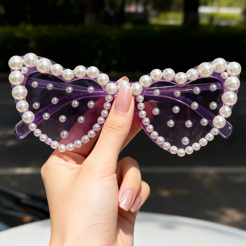 Fashionable women's heart-shaped sunglasses, decorated with pearls, perfect for bridal photoshoots & parties.