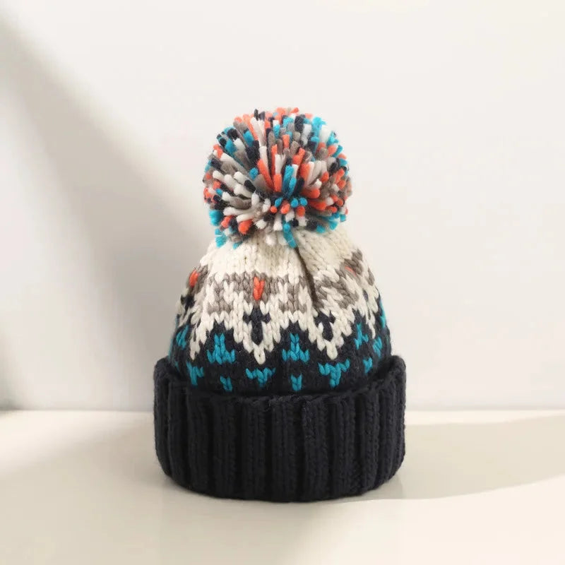 Stylish women's winter beanie featuring a festive snowflake pattern, cozy pom-pom, and warm ribbed cuff.