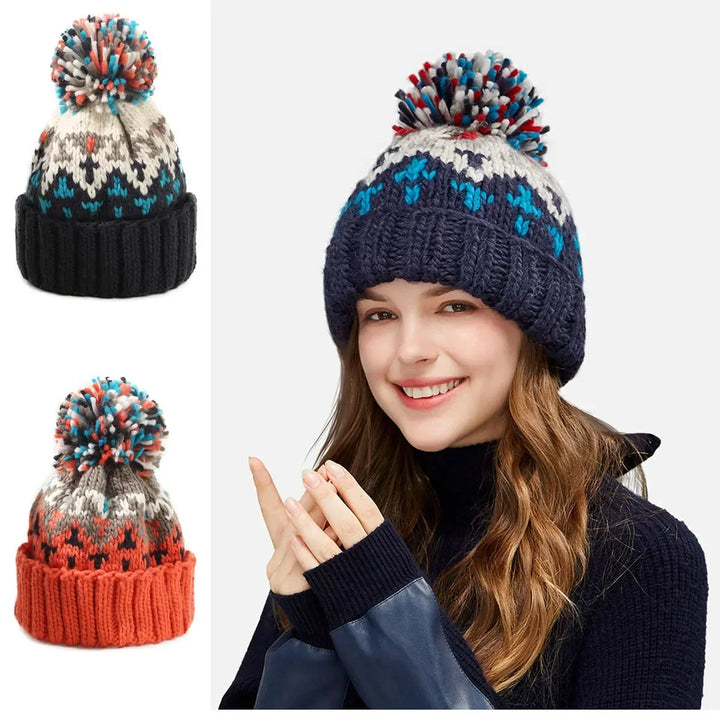 Cozy women's winter hat with a playful pom-pom and elegant snowflake pattern, finished with a warm ribbed cuff.