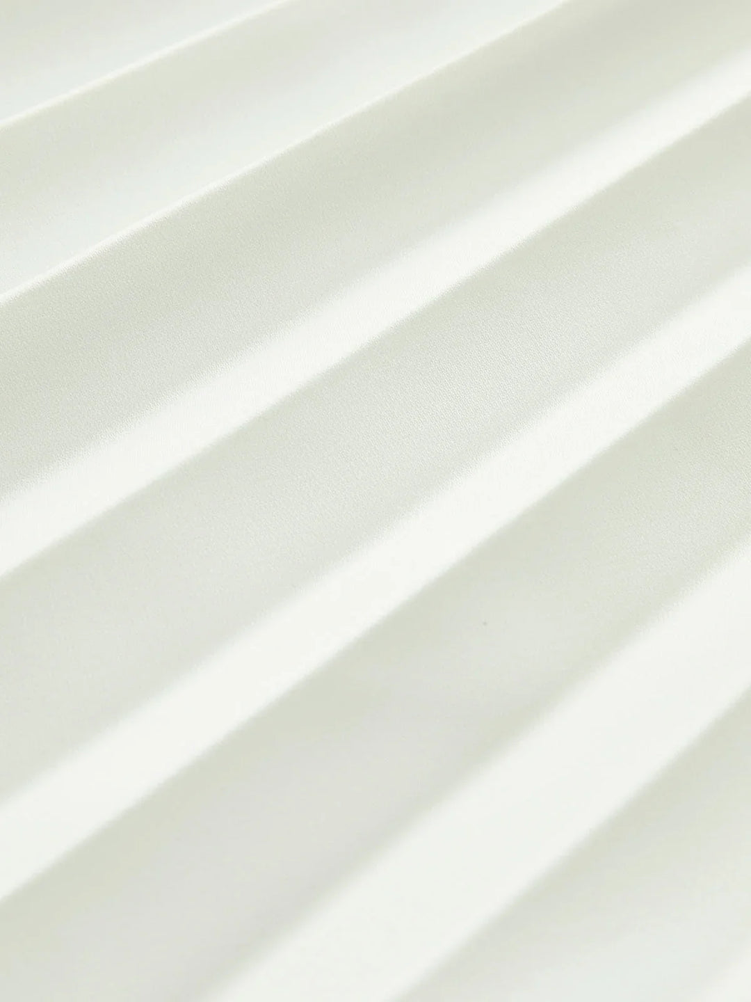 Formal white strapless maxi dress, featuring elegant pleats, an asymmetric hem, and side split.