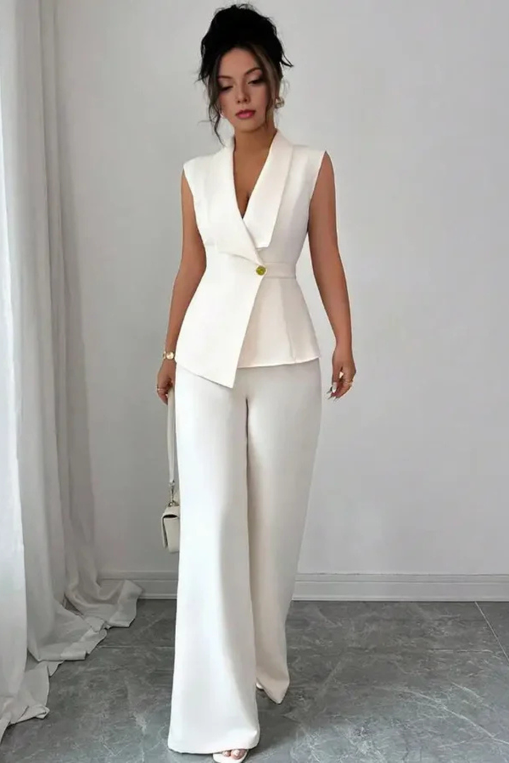 Elegant white sleeveless blazer suit for women. Tailored professional wear with wide leg trousers for a chic look.