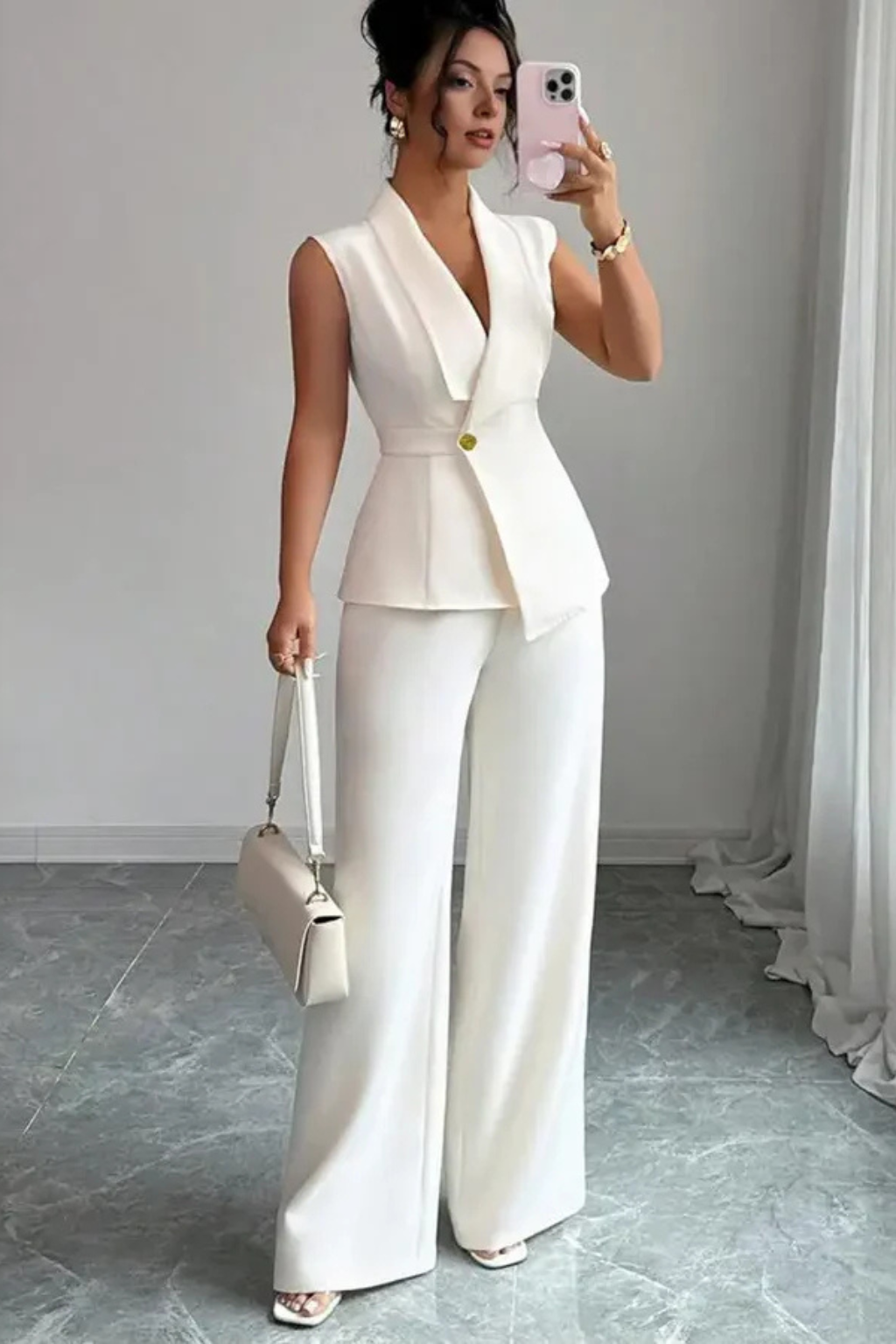 White women's tailored suit set: sleeveless blazer & wide leg trousers. Versatile for professional and formal wear.