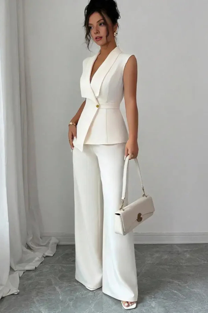 Fashionable women's white tailored suit set: sleeveless blazer, comfortable wide leg trousers. Modern professional attire.