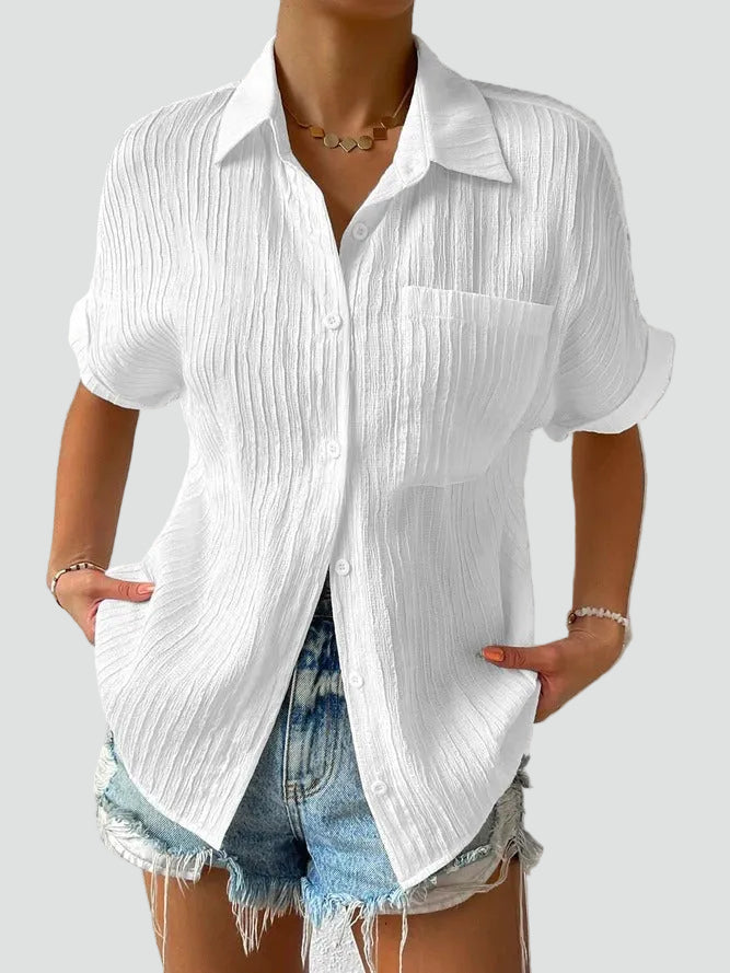 Women's white textured button-up blouse, a relaxed short sleeve summer shirt for casual wear.