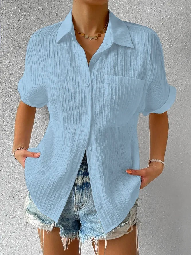 Versatile textured button-up blouse, a relaxed short sleeve women's shirt ideal for summer.