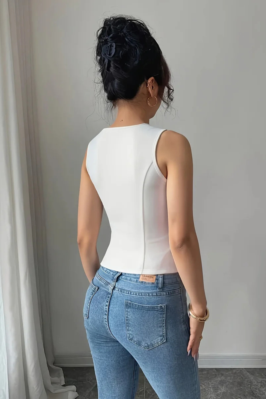 Tailored women's white V-neck waistcoat, fitted for summer, featuring a stylish button front and unique metal buckle.