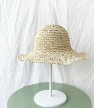 Stylish women's crochet straw bucket hat with wide brim. Perfect summer accessory for beach trips or casual wear.