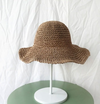 Lightweight, breathable women's crochet straw bucket hat with wide brim. Essential summer hat for beach & casual comfort.