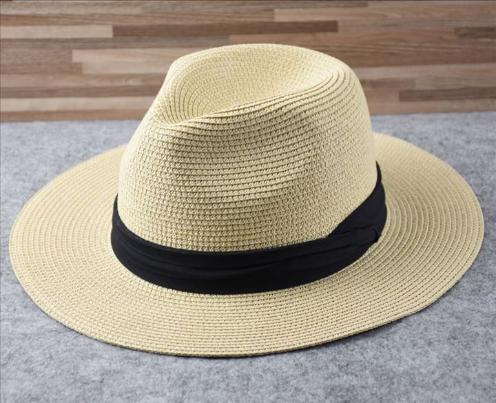 Stylish women's straw sun hat with a wide brim for maximum UV sun protection at the beach.