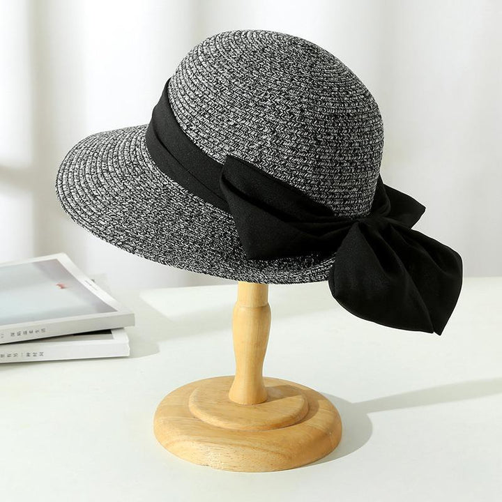 Vacation-ready women's wide-brim straw sun hat, essential for beach days & summer style.