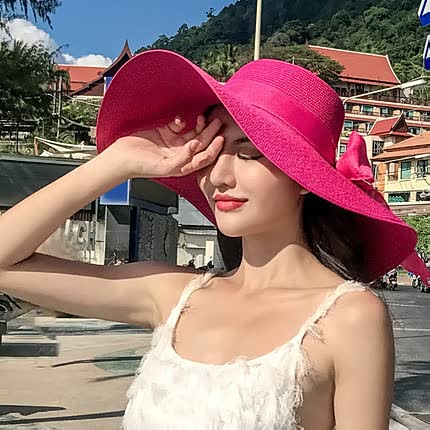 Stylish women's straw sun hat, wide brim for UV protection. Ideal beach, pool & holiday accessory.