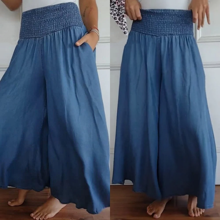 Women's wide-leg high-waist smocked denim trousers for a stylish, comfortable look.