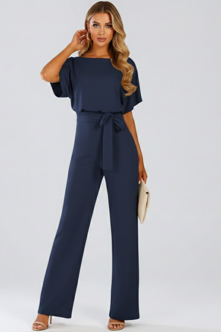 Modern women's short-sleeve wide-leg jumpsuit, featuring an elegant belted silhouette for a stylish look.