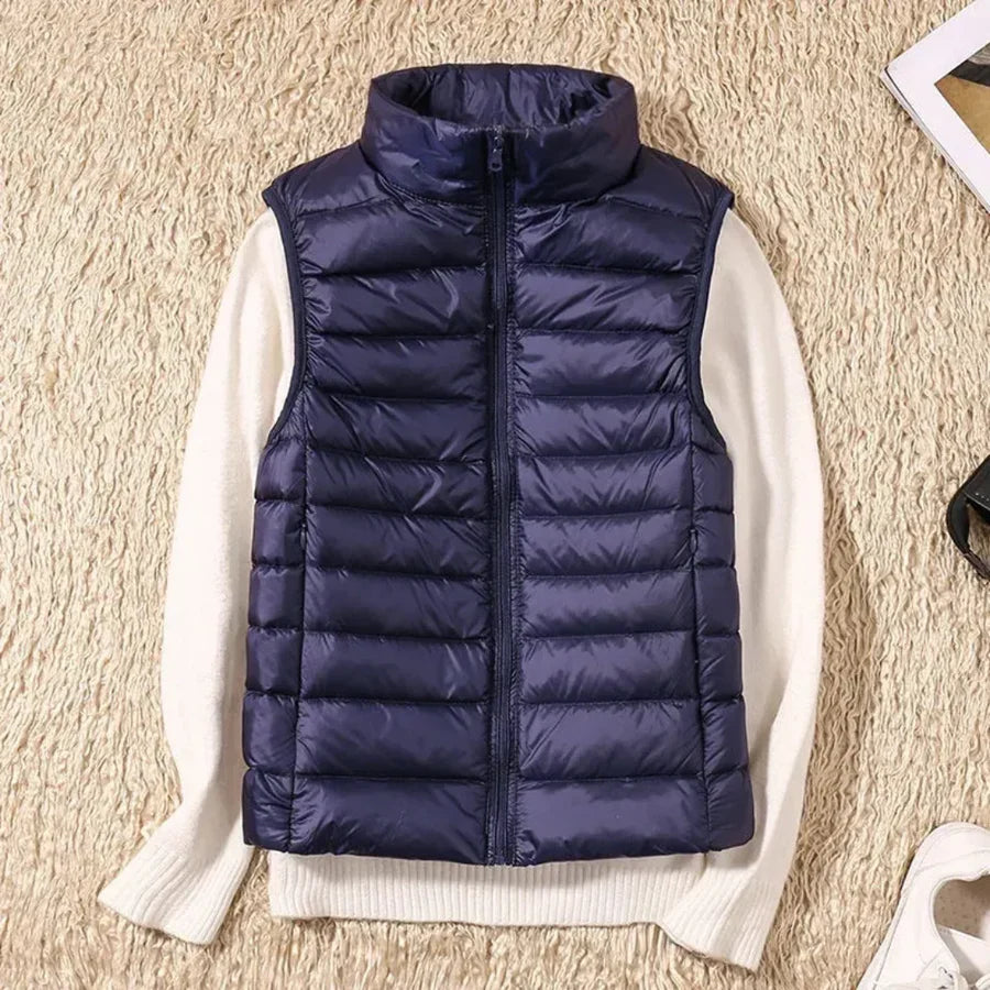 Women's full-zip sleeveless bodywarmer. Wind-resistant outerwear for comfortable layering.