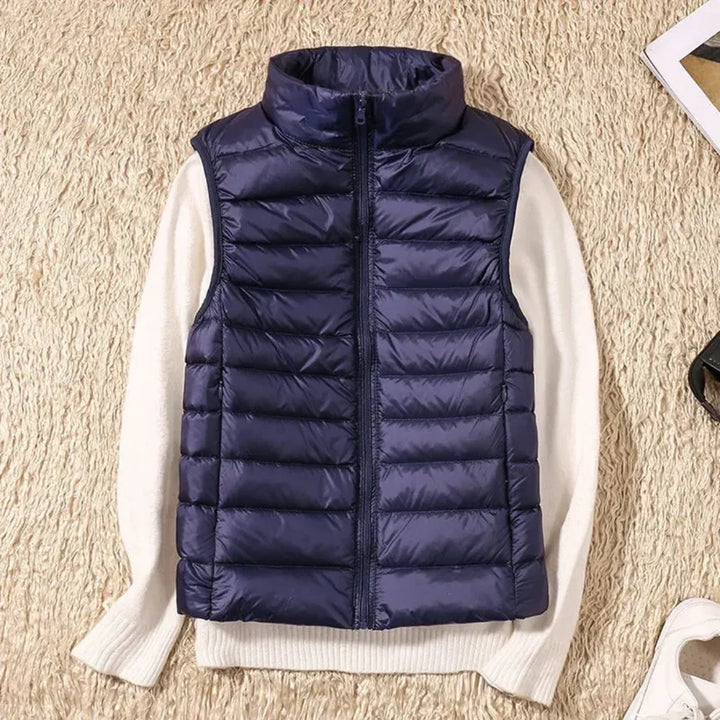 Women's full-zip sleeveless bodywarmer. Wind-resistant outerwear for comfortable layering.