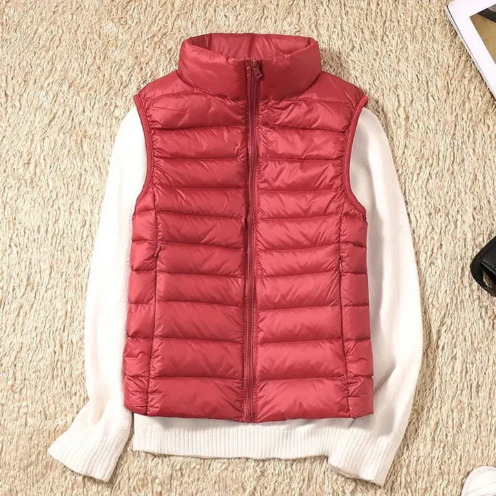 Women's sleeveless zippered outerwear, offers wind resistance & warmth for layering.