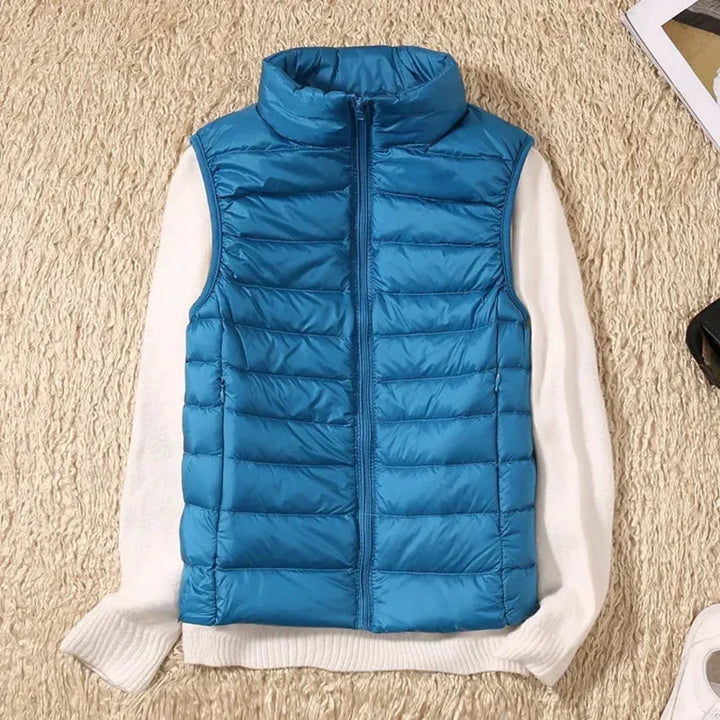 Women's outdoor wind-resistant vest with full zip. Sleeveless design for active layering.
