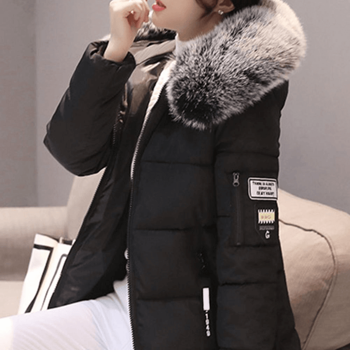 Model in a grey women's mid-length puffer coat, chic & warm winter jacket.