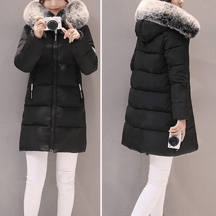 Close-up of a women's hooded puffer coat, showcasing warm, windproof fabric.