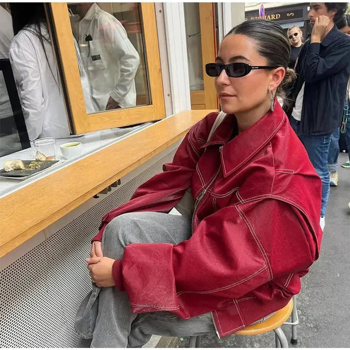 Women's wine red oversized quilted bomber jacket, a fashionable style with eye-catching contrast stitching.