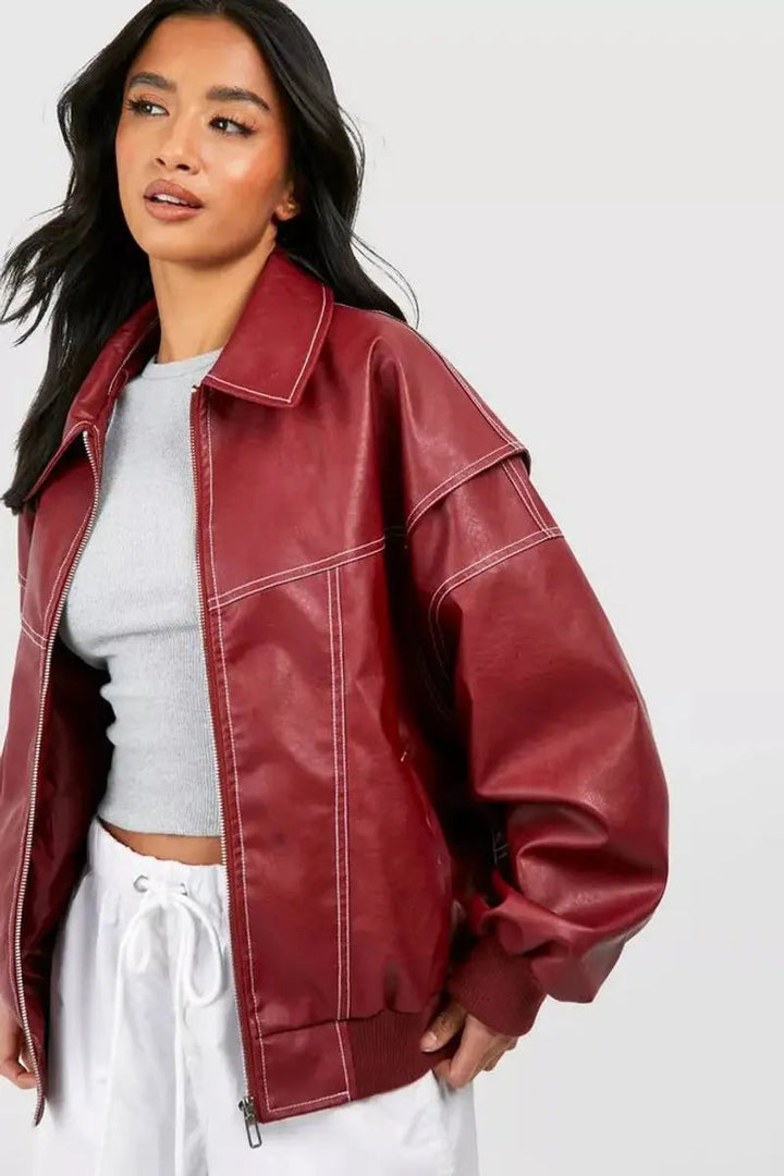 Stay warm in this women's wine red oversized quilted winter jacket with unique contrast stitching.
