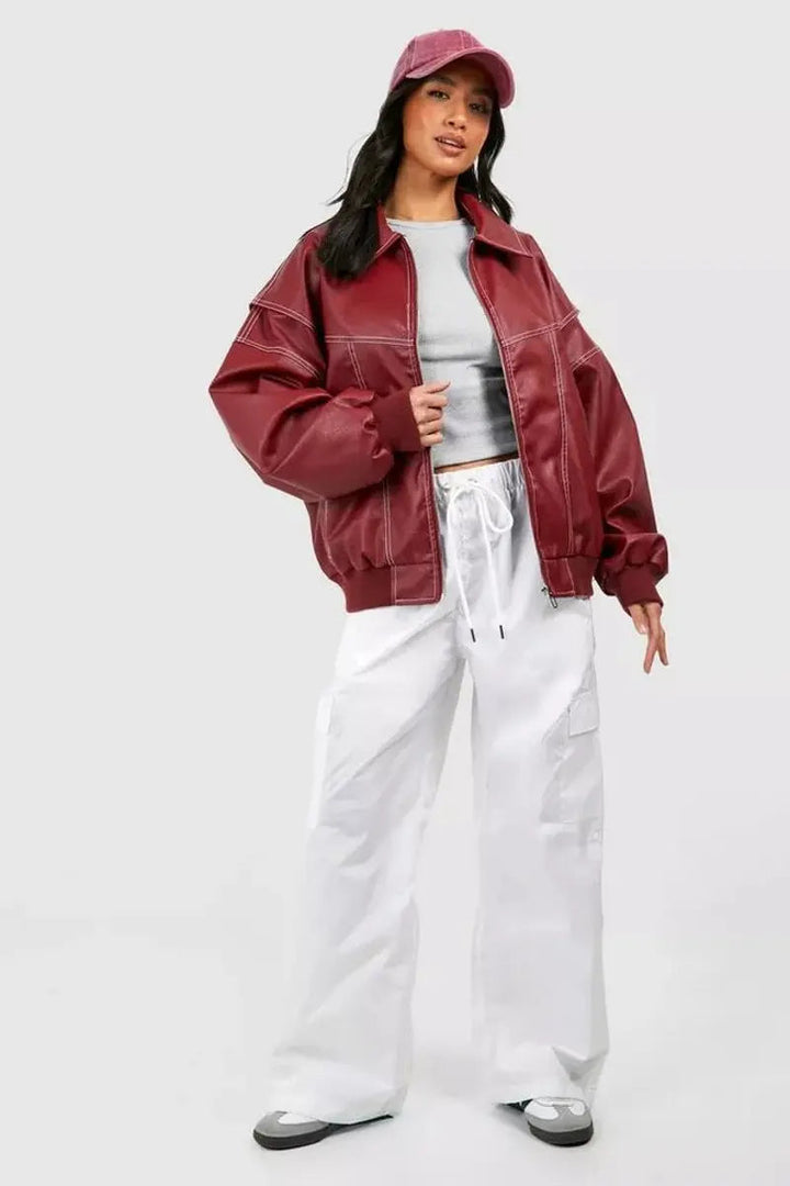 Women's oversized quilted jacket in wine red with chic contrast stitching. Perfect casual outerwear.