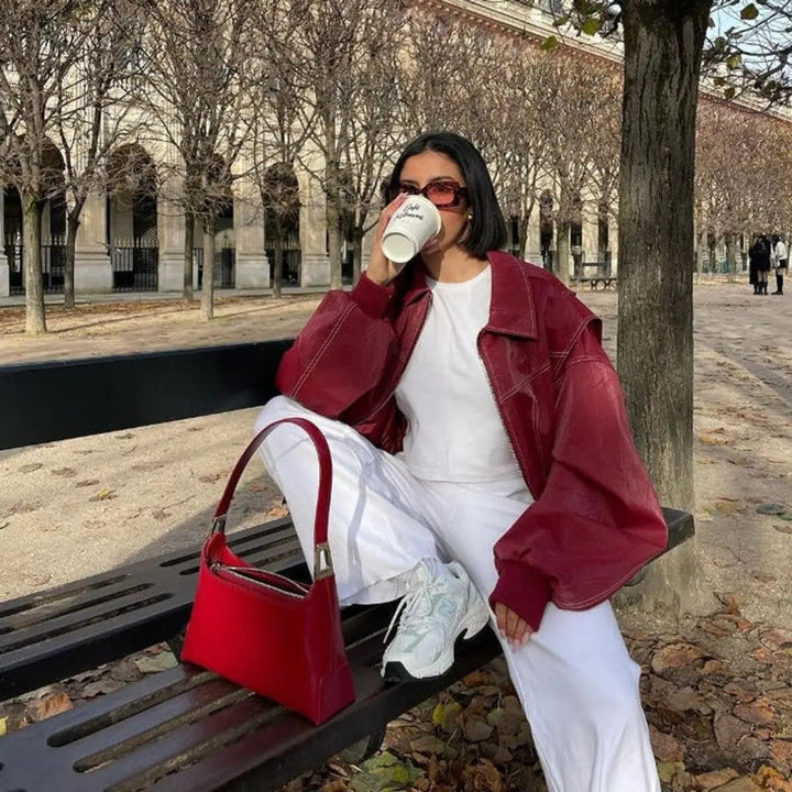 Cozy women's wine red oversized quilted jacket with fashionable contrast stitching. Great for autumn.