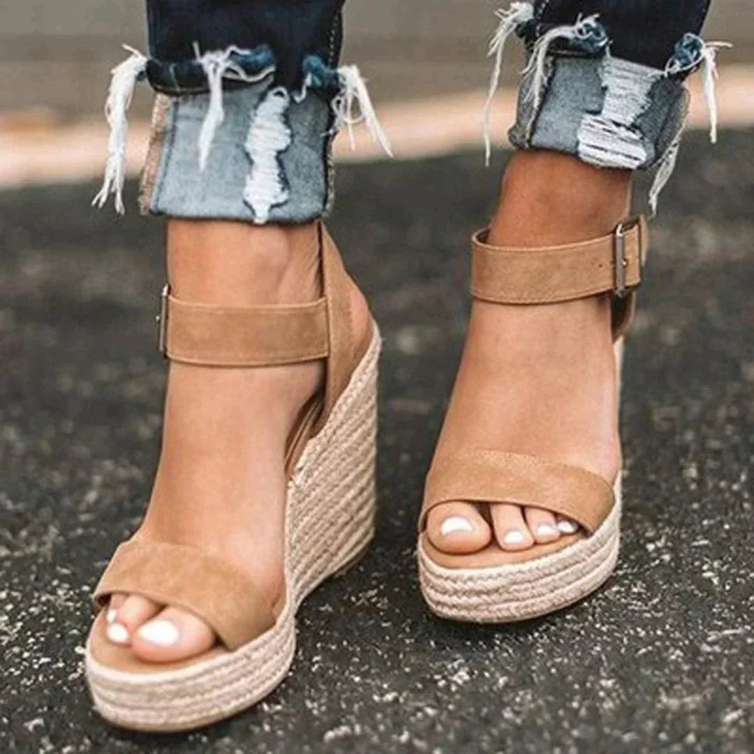 Women's woven wedge open-toe sandals with adjustable ankle strap. Comfortable & elegant summer footwear.